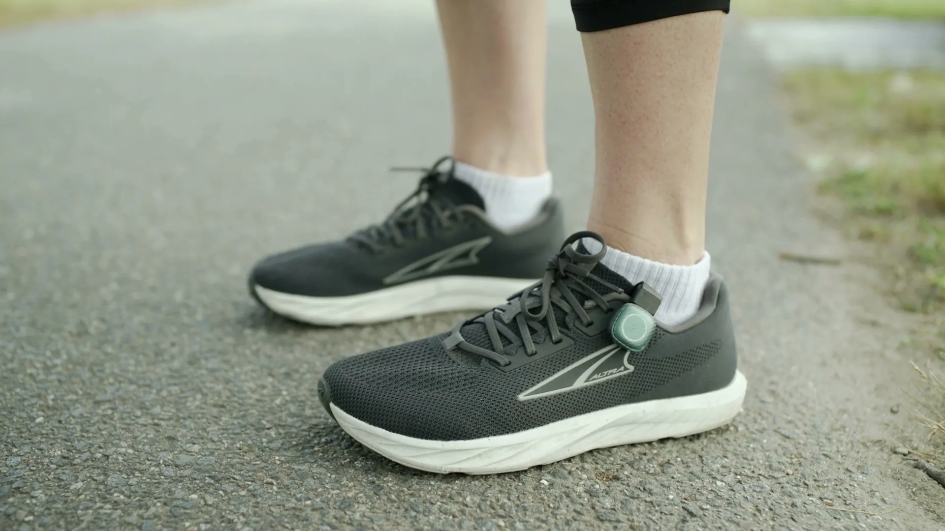 A STRIV pod clipped to the laces of a running shoe